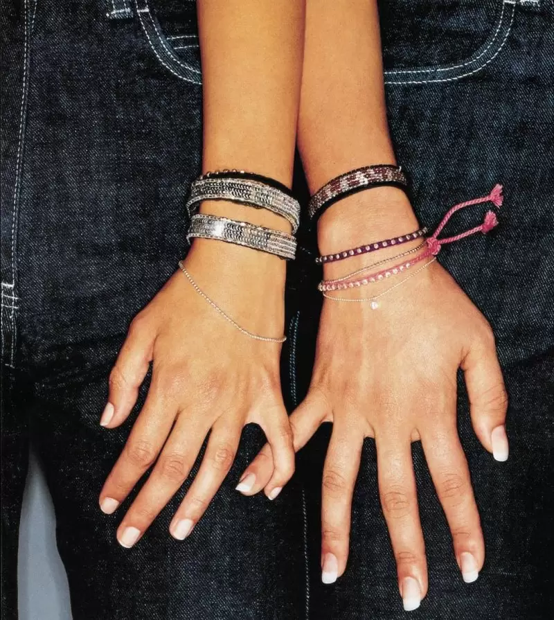 two manicured hands with bracelets