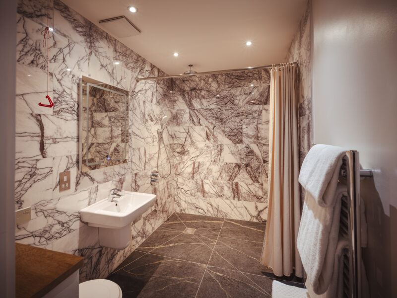 beautiful large bathroom with large shower head