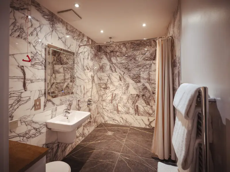 beautiful large bathroom with large shower head