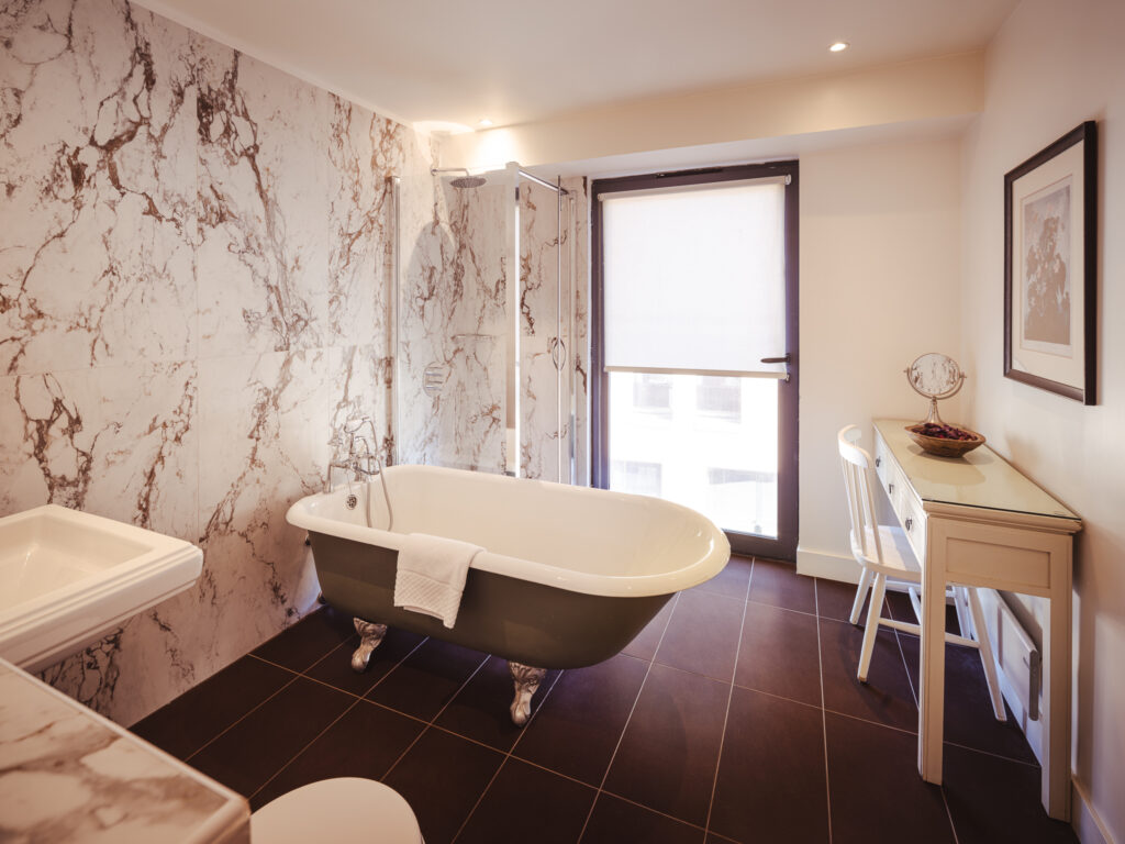 hotel bathroom with freestanding roll top bath