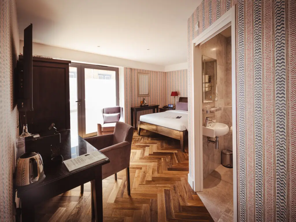 large double hotel room with unique wallpaper