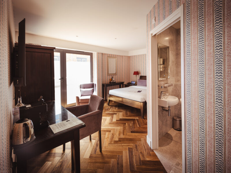 large double hotel room with unique wallpaper