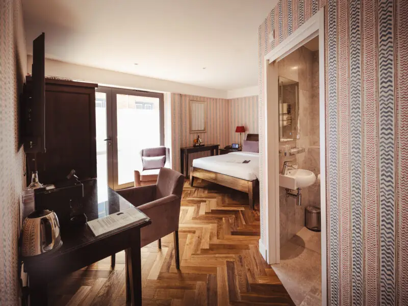 large double hotel room with unique wallpaper