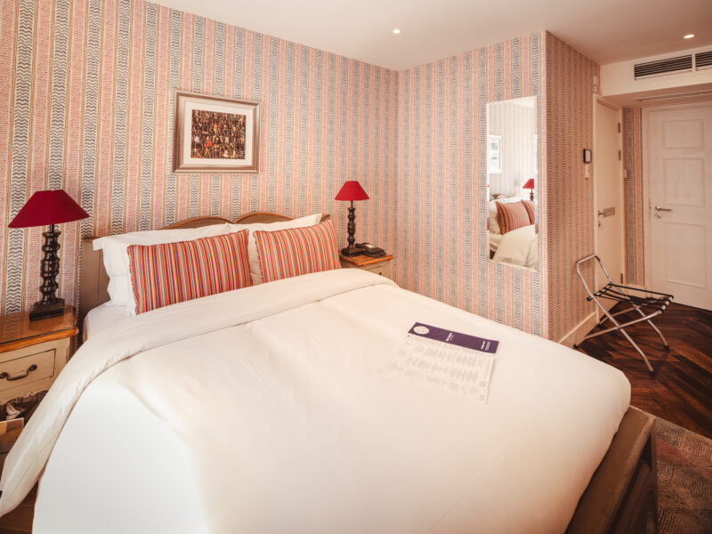 hotel room with red lamps and red and yellow pillows