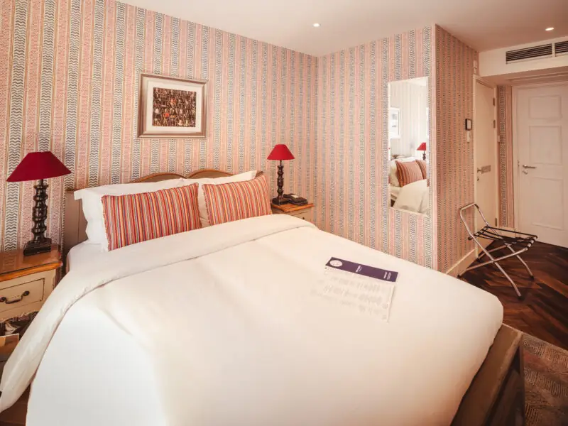 hotel room with red lamps and red and yellow pillows