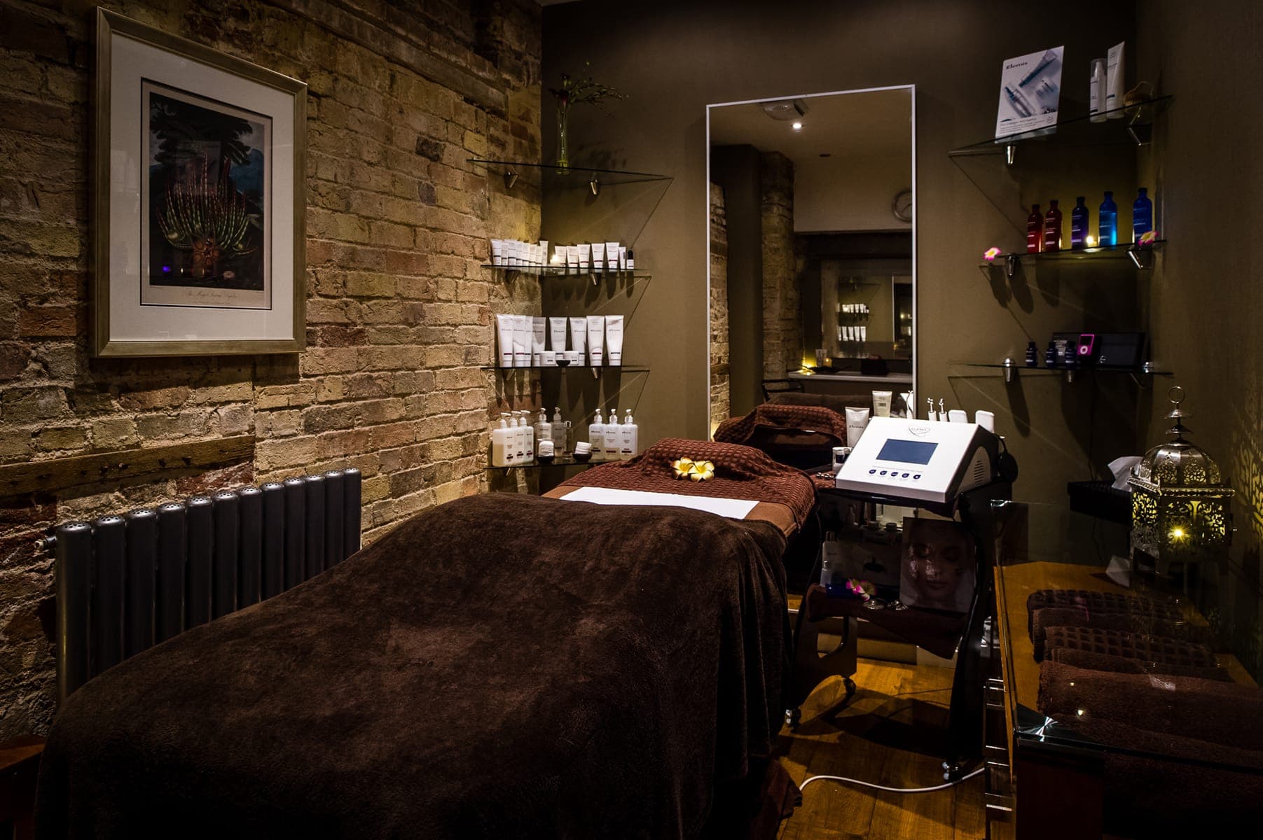 spa bed with elemis products, dimmed lights