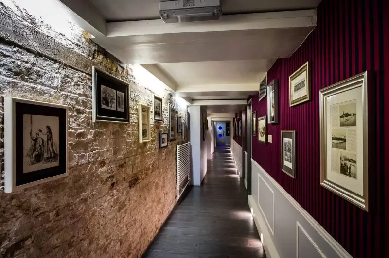 corridor walls with photo frames and posters