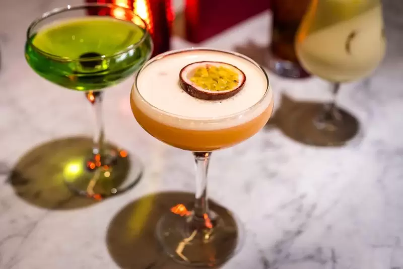 martini cocktail with passionfruit and green cocktail
