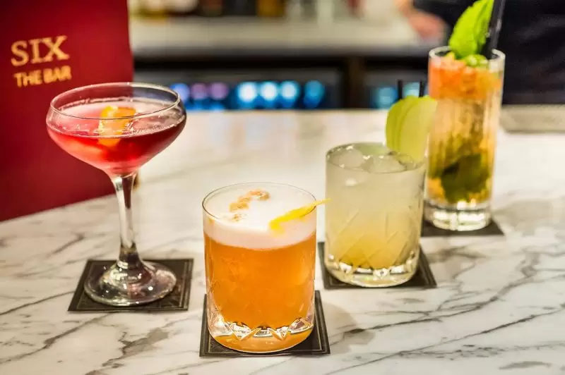 four cocktails on the bar at SIX