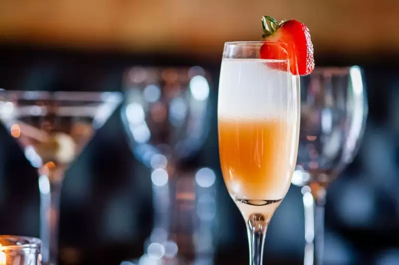 champagne glass with strawberry on the rim