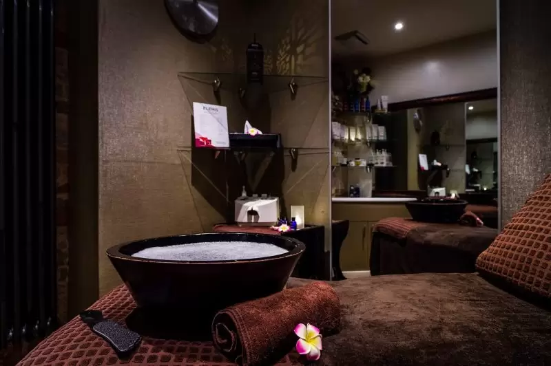 spa with soapy bowl sitting on the lounge bed for foot treatment