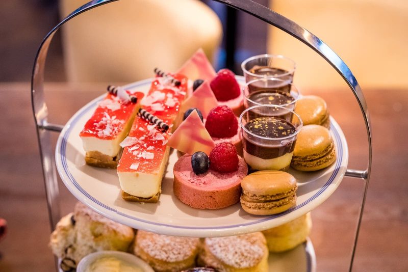 top of afternoon tea with cheesecakes macaroons and other sweet treats