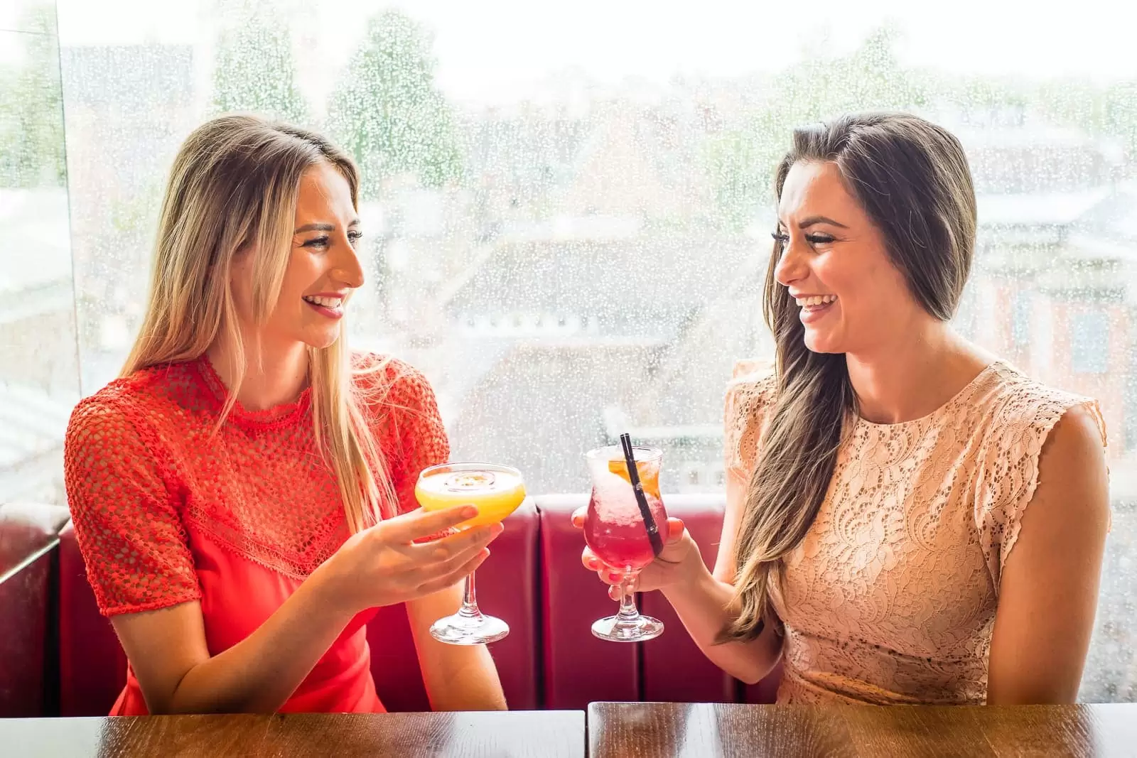 two ladies drinking cocktails in a restaurant