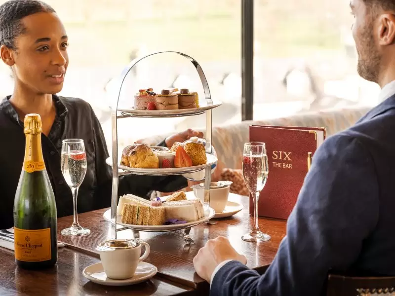couple having champagne afternoon tea