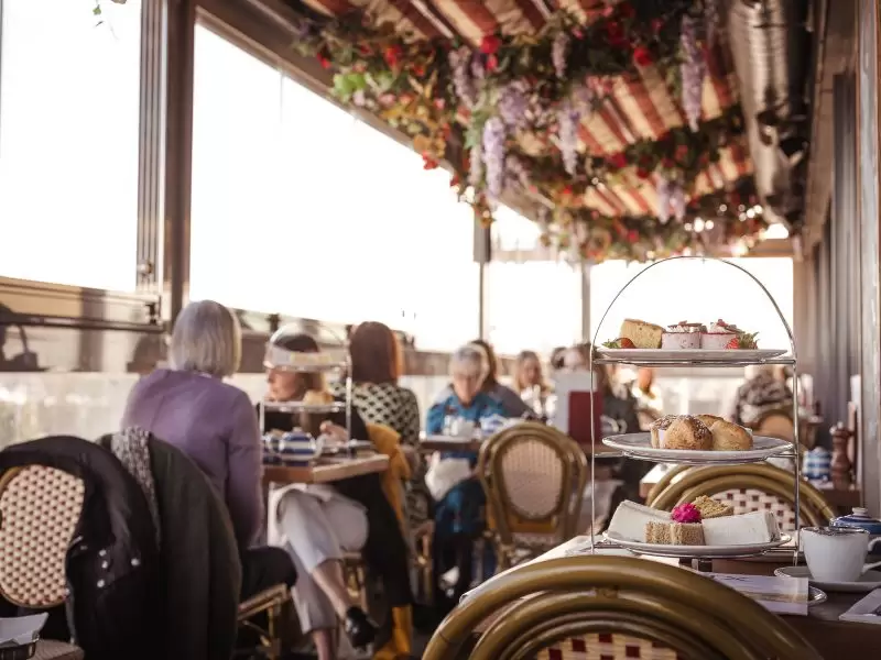 afternooon tea outside with two ladies enjoying their tea