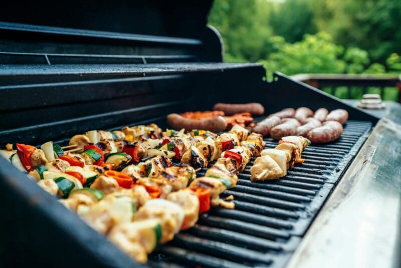 bbq with sausages and skewers grilling
