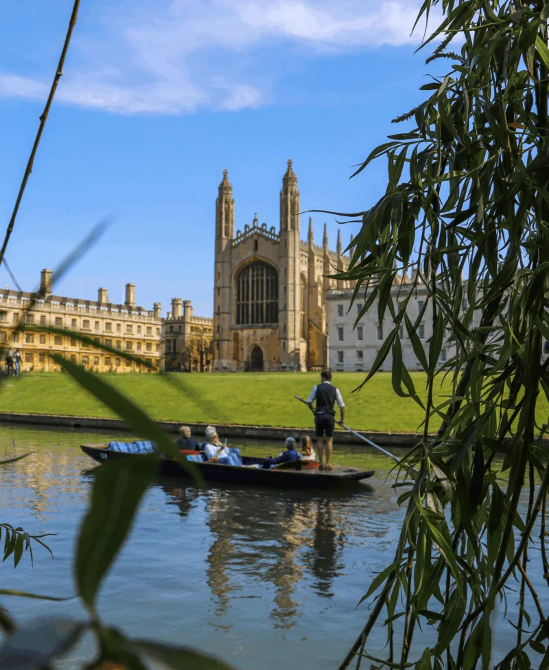 punting on the river cam with cathedral in the background in cambridge